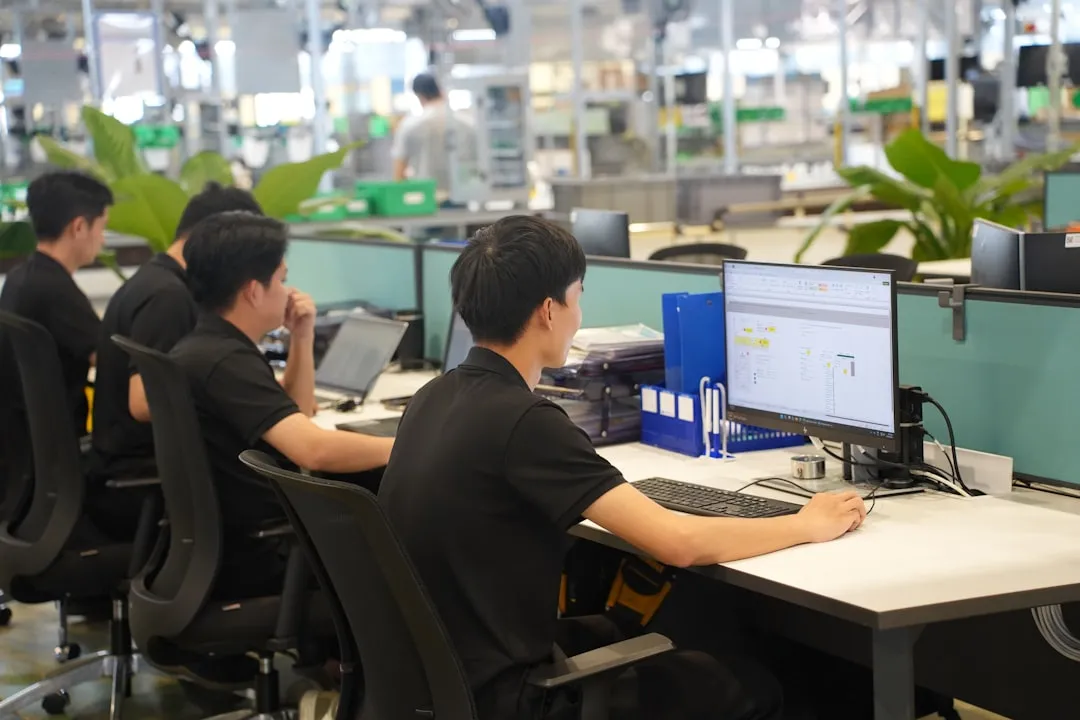 Workers at computers in a modern office setting