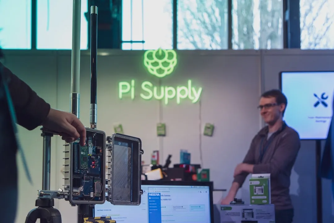 man in brown shirt standing near black and gray electronic device